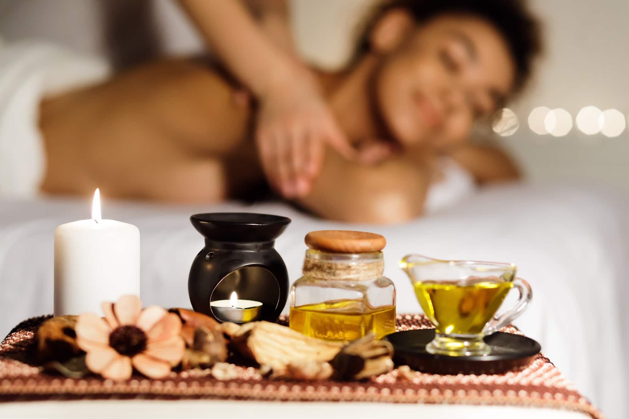 Aroma massage. Relaxed lady enjoying back massage