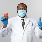 Young African-American Doctor on Grey