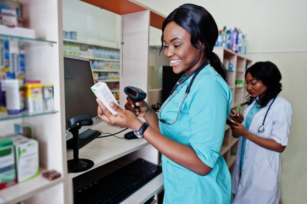 African american pharmacist working in drugstore