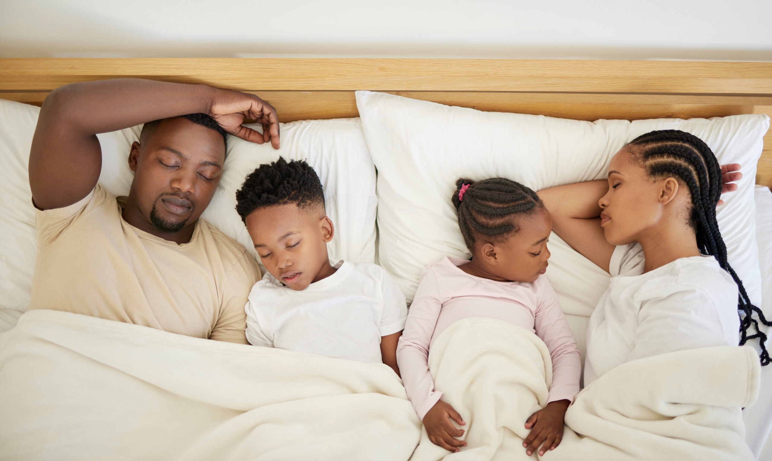 A family that naps together stays together. Shot of a family sleeping in bed at home.